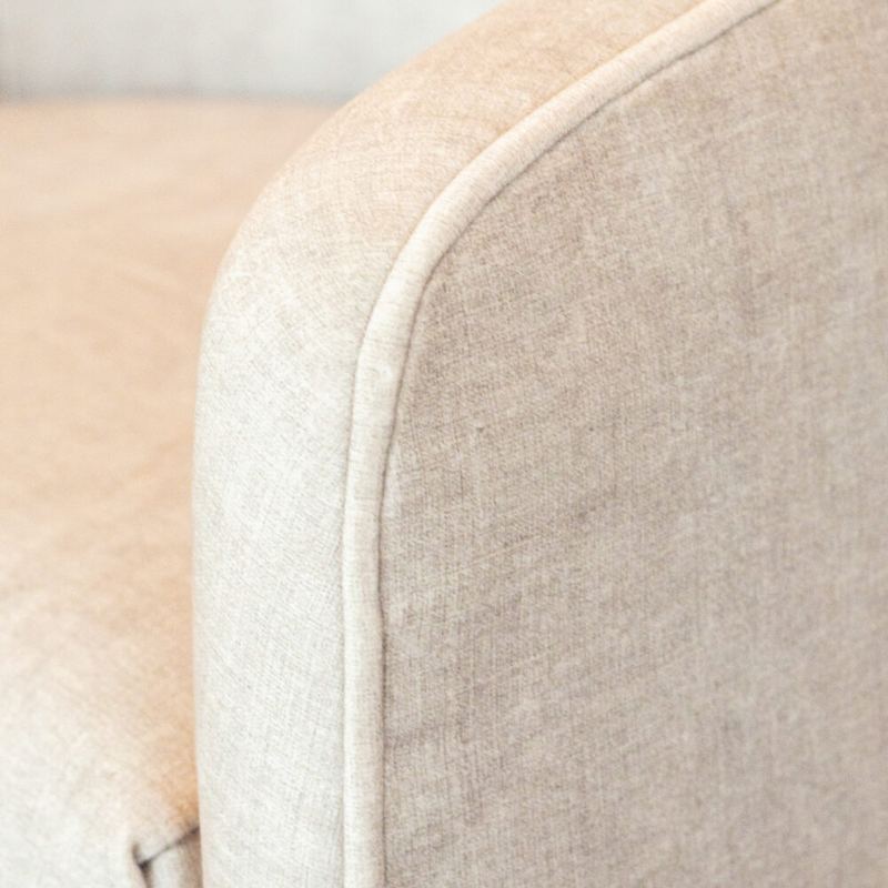 Hand-piped seam running along the arm of the chair